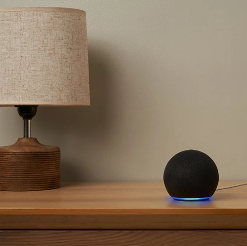 Amazon Echo Dot 5th Gen smart speaker on a table.