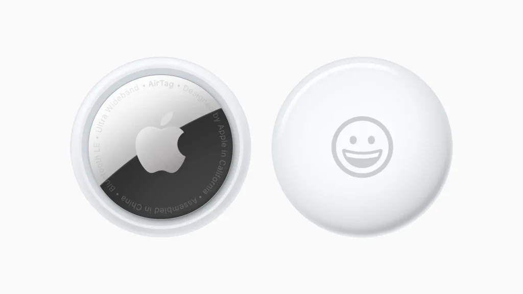Apple AirTag front and back view showing Apple logo and emoji engraving.