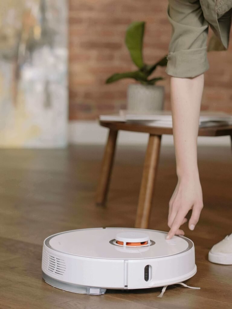 Roborock Qrevo series robot vacuum cleaner, one of the best smart home gadgets 2026, being operated on a wooden floor.